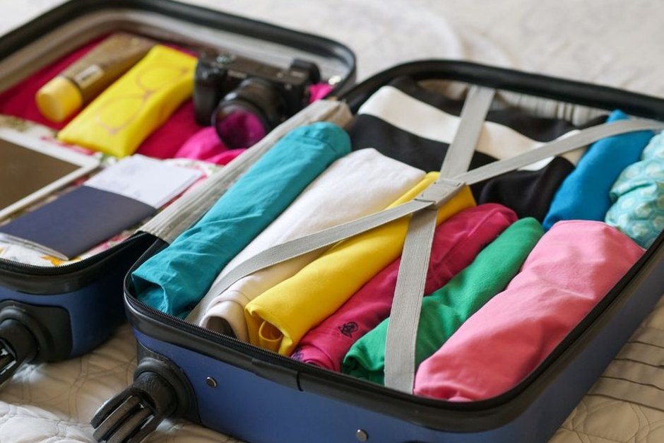 An open suitcase neatly packed for a short trip.