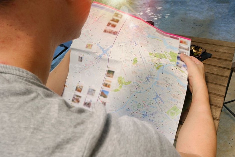 A traveller studying a folded city map.