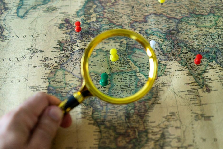 A magnifying glass placed over a detailed map.